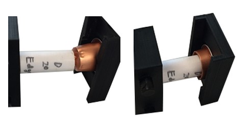 Two angles of the 3D-printed prototype of the cover part in its test fixture
